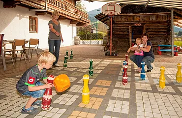 Familie spielt großes Mensch ärgere dich nicht im Aussenspielbereich